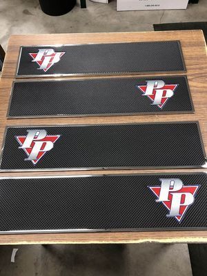 Four rectangular black bar mats with a