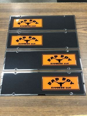 Four license plates, orange and black