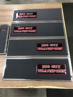 Four black and silver step plates with