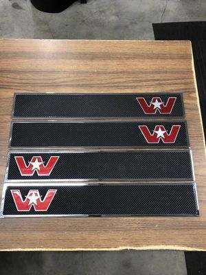 Four black rectangular Western Star emblem panels with red and white logos and chrome trim.