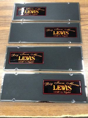 Four custom license plates with carbon fiber backgrounds, chrome trim, and a