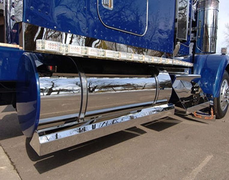 Blue and chrome semi-truck, parked. Polished chrome side panels reflect the surroundings.