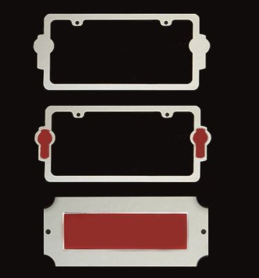Silver metal license plate frames and a red-backed rectangle on a black background.