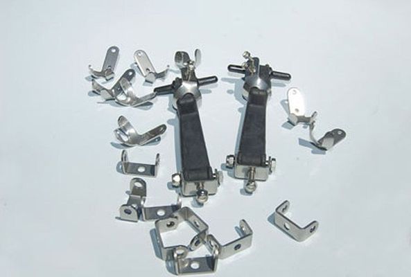 Metal toggle latches and mounting brackets scattered on a white surface.