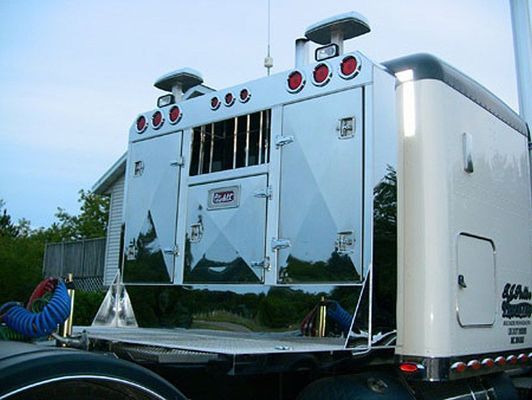 Chrome truck sleeper cab with storage compartments and lights.