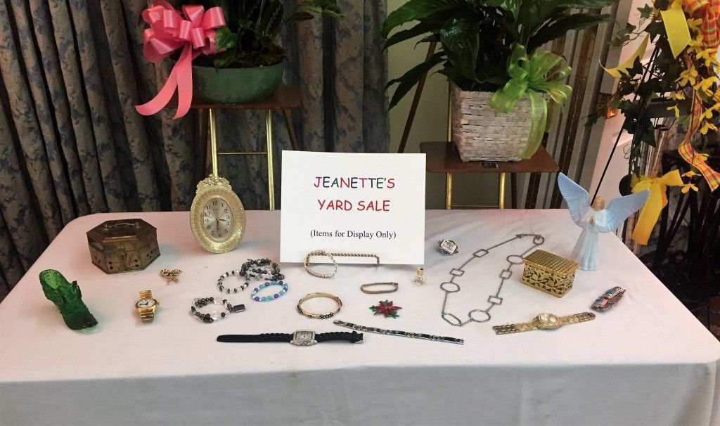 A table with jewelry and a sign that says ' peace ' on it