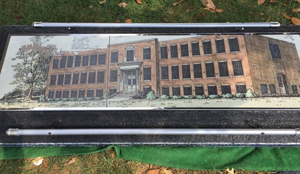 A picture of a building on a bench in a park