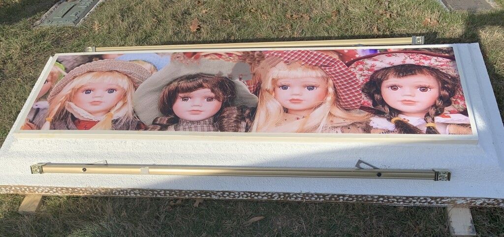 A picture of four dolls sitting on top of a table.