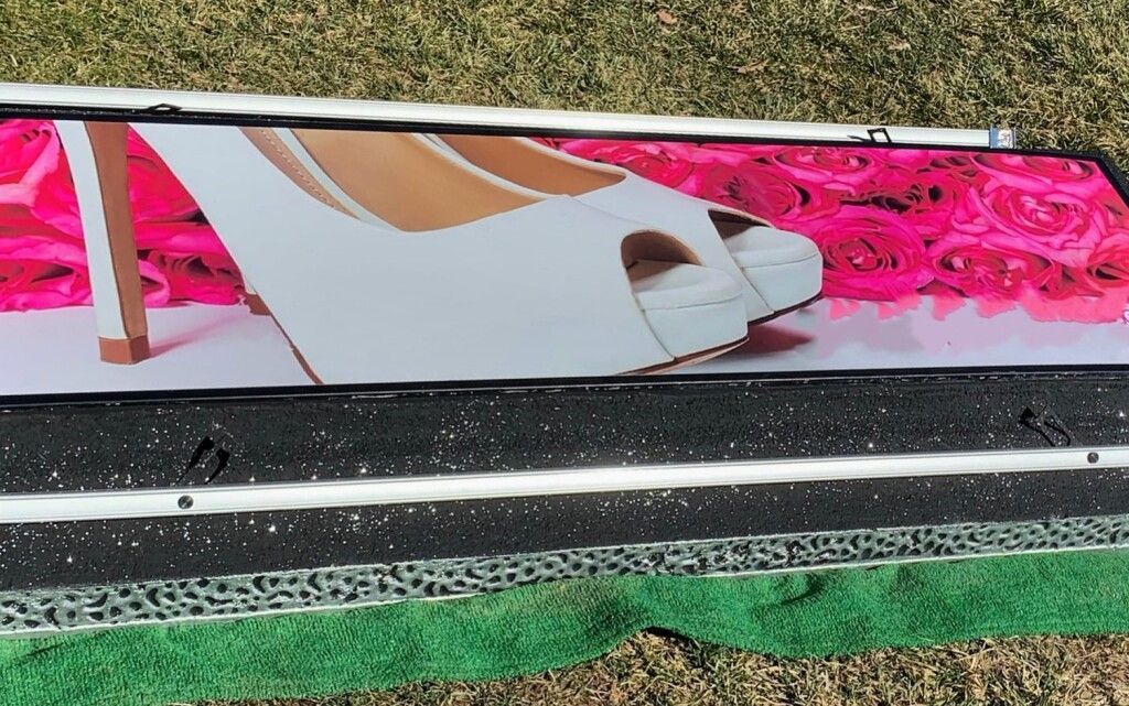 A picture of a woman 's shoe is on a skateboard.