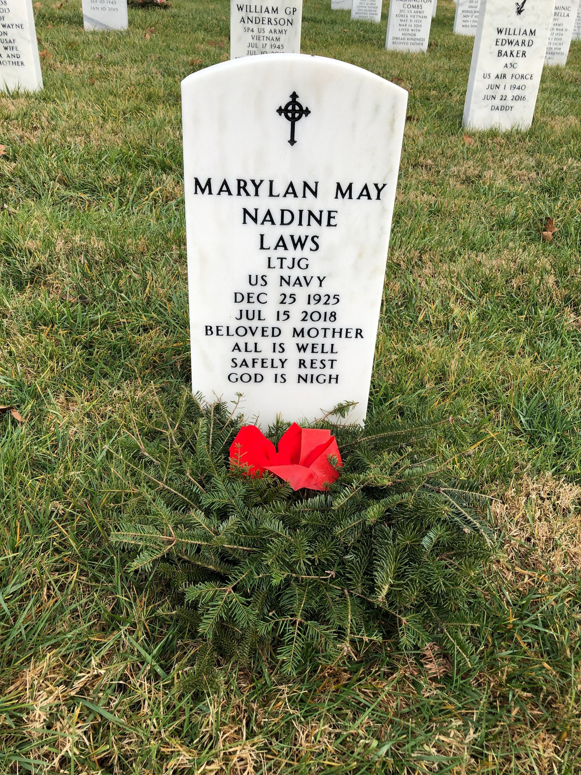 A gravestone for marylan may nadine lewis is in a cemetery.