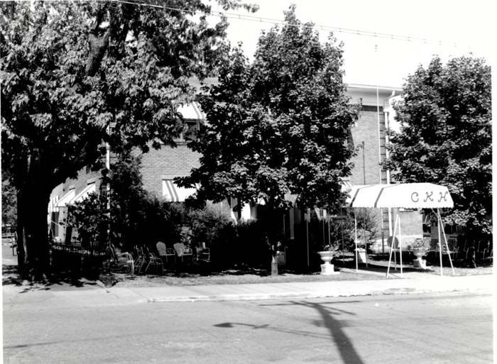 A black and white photo of a building that says cxa