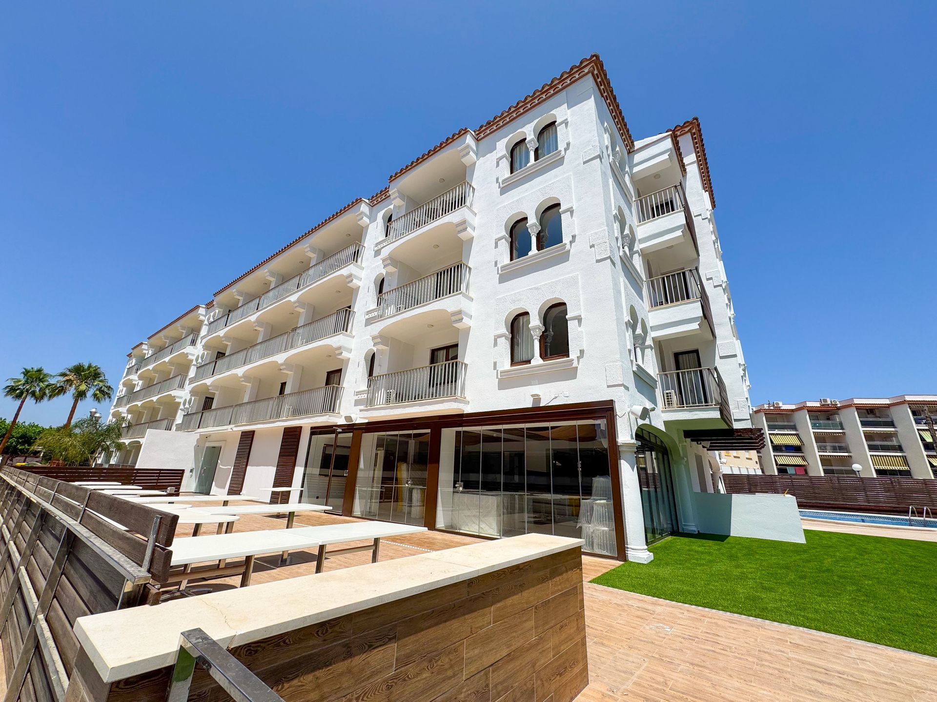 A green and white house with stairs leading up to it