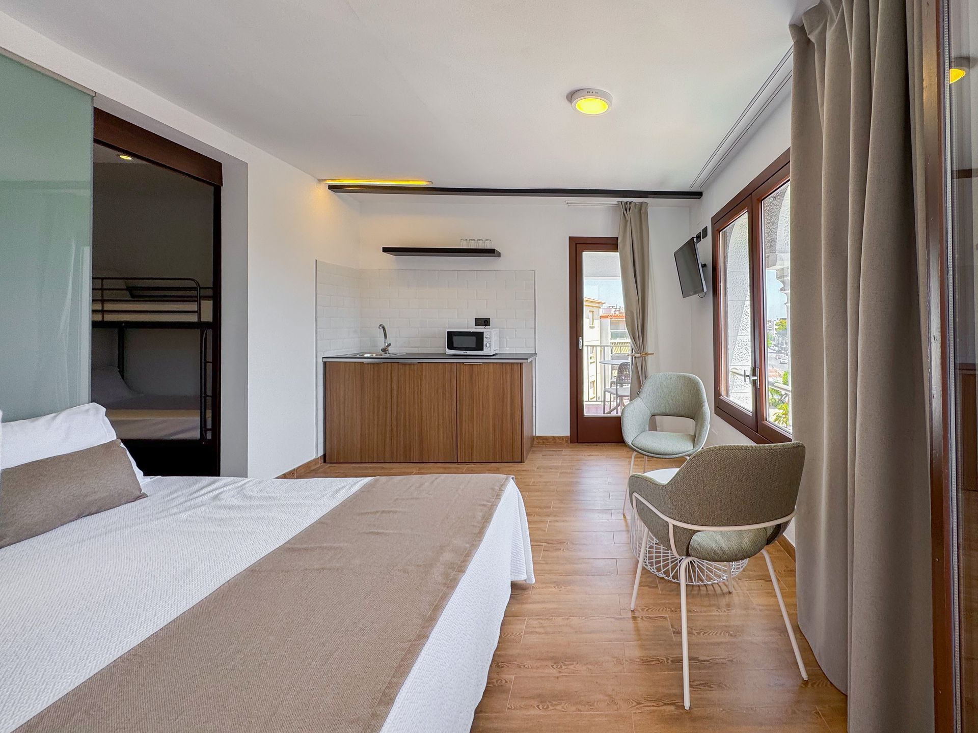 A hotel room with a painting of a woman on the wall