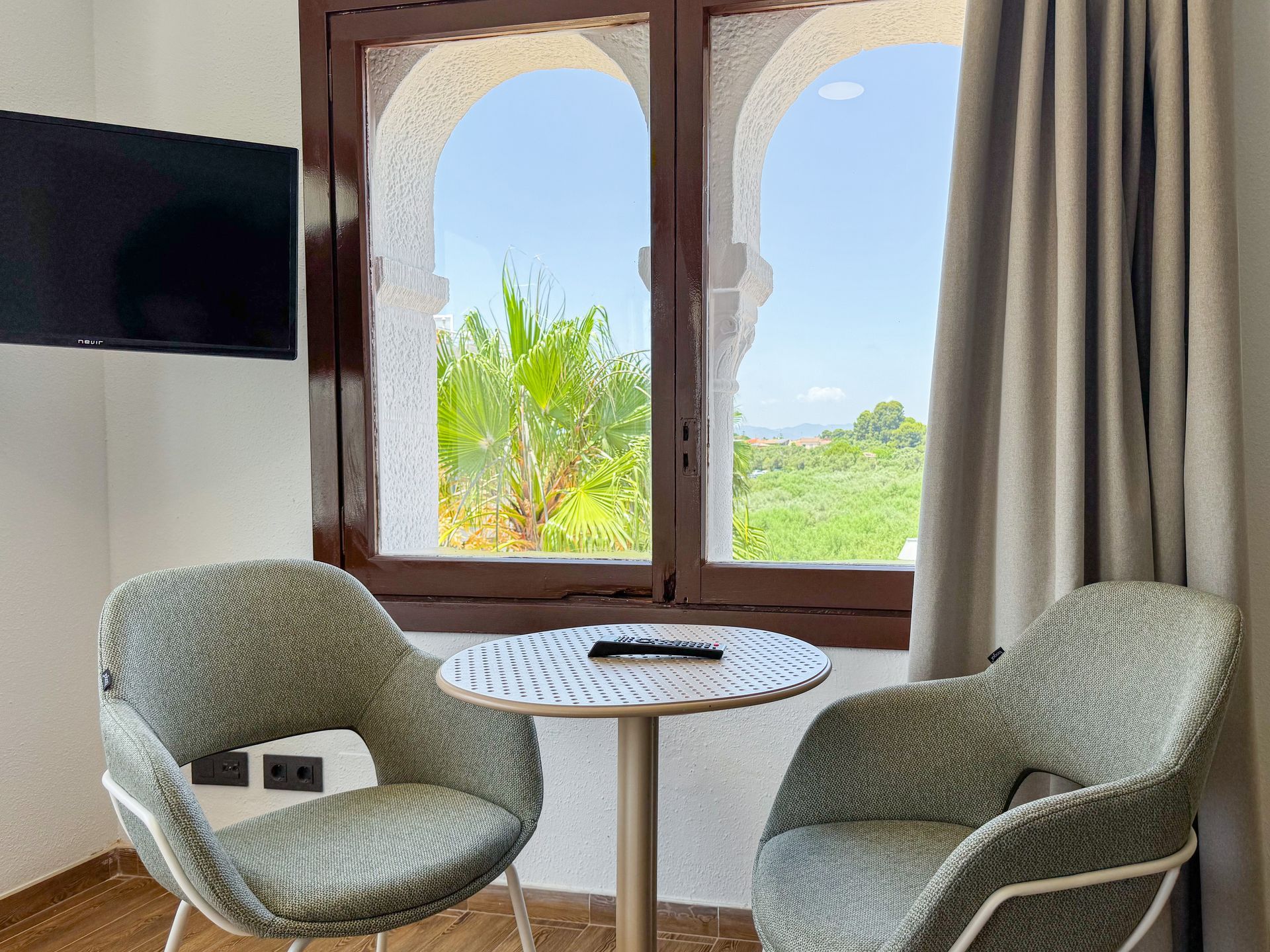 A bathroom with a walk in shower , sink and mirror.