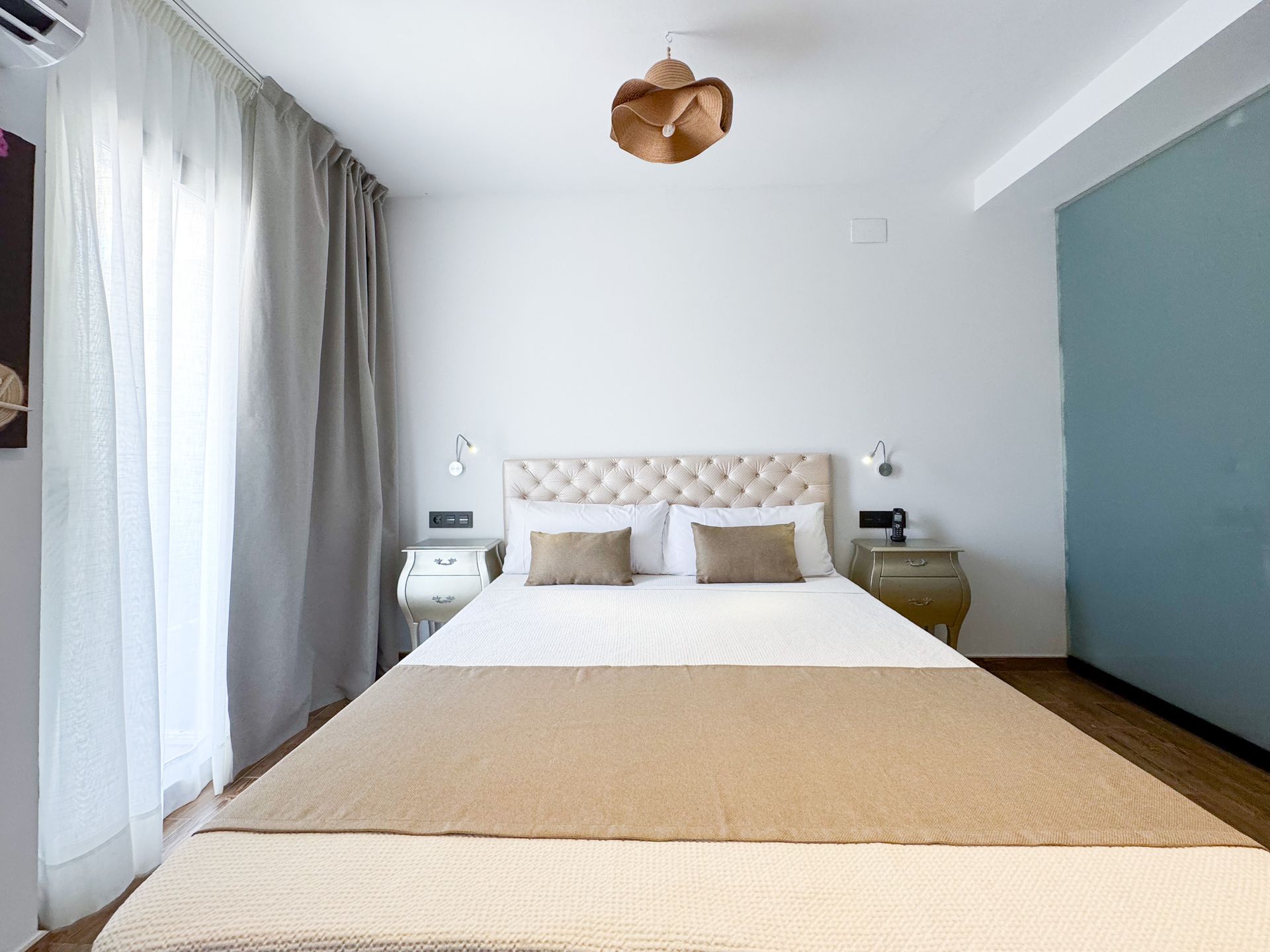 A bathroom with a walk in shower , sink and mirror.