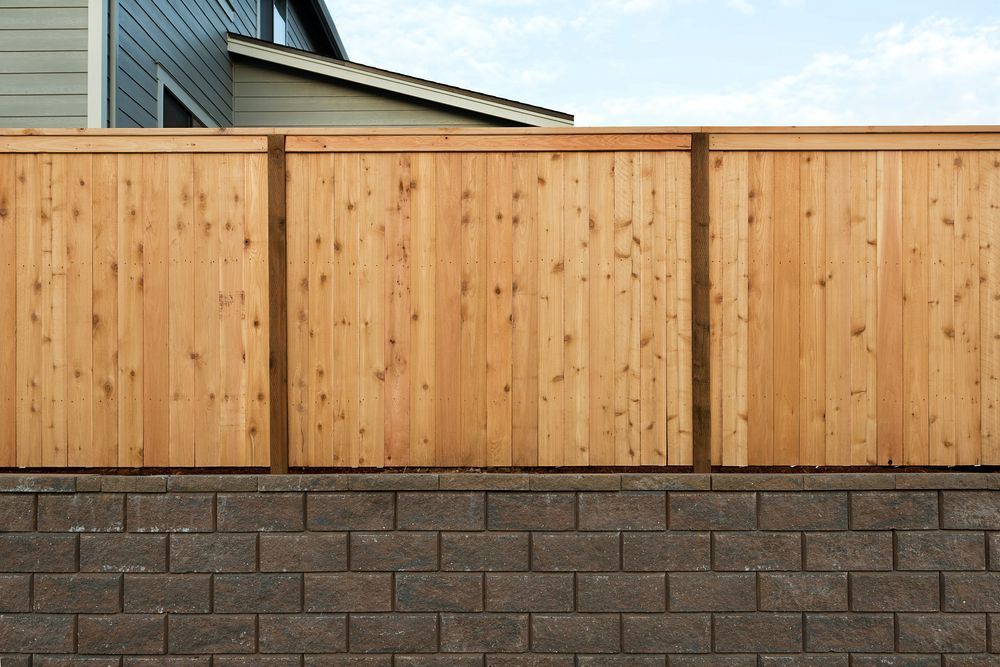 A Wooden Fence Atop a Brown Brick Wall — Smiddy's Services In Wyee, NSW