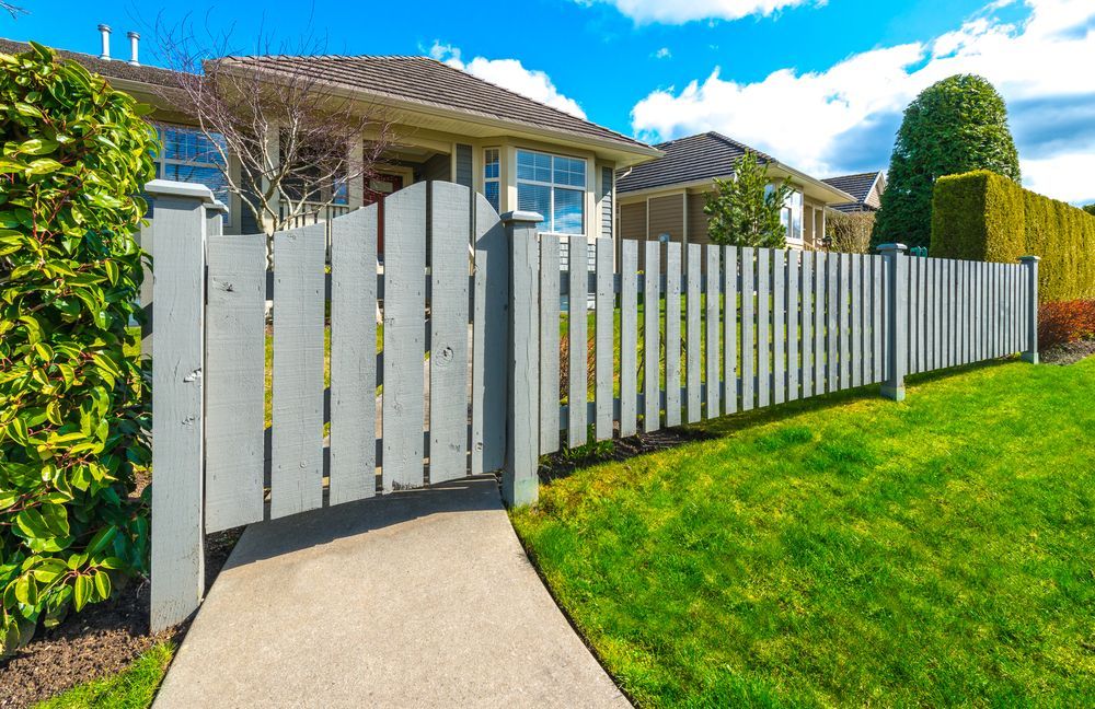 A Gray Picket Fence With Gate — Smiddy's Services In Morisset, NSW