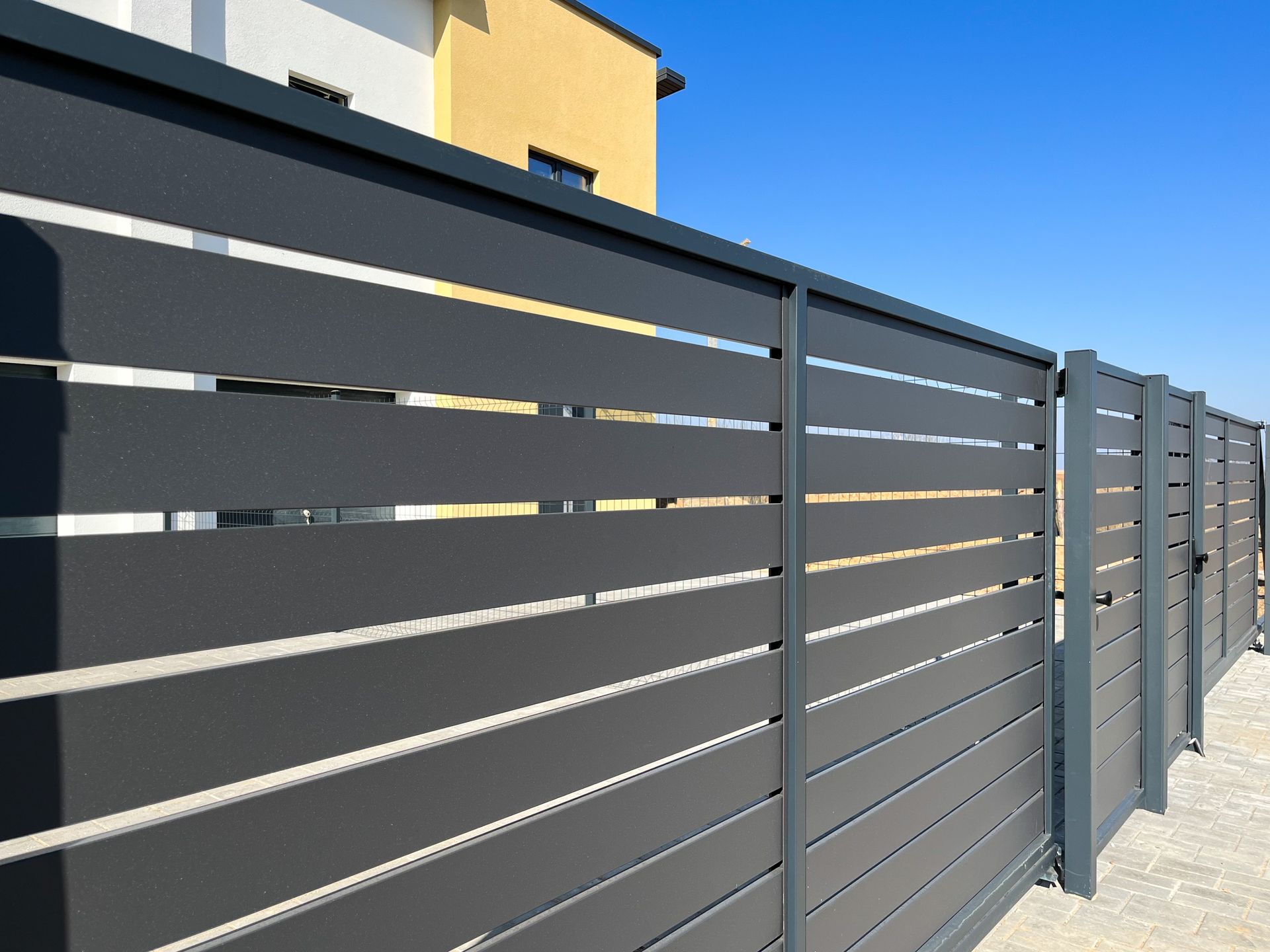 A Dark Gray Horizontal Slat Fence — Smiddy's Services In Erina, NSW