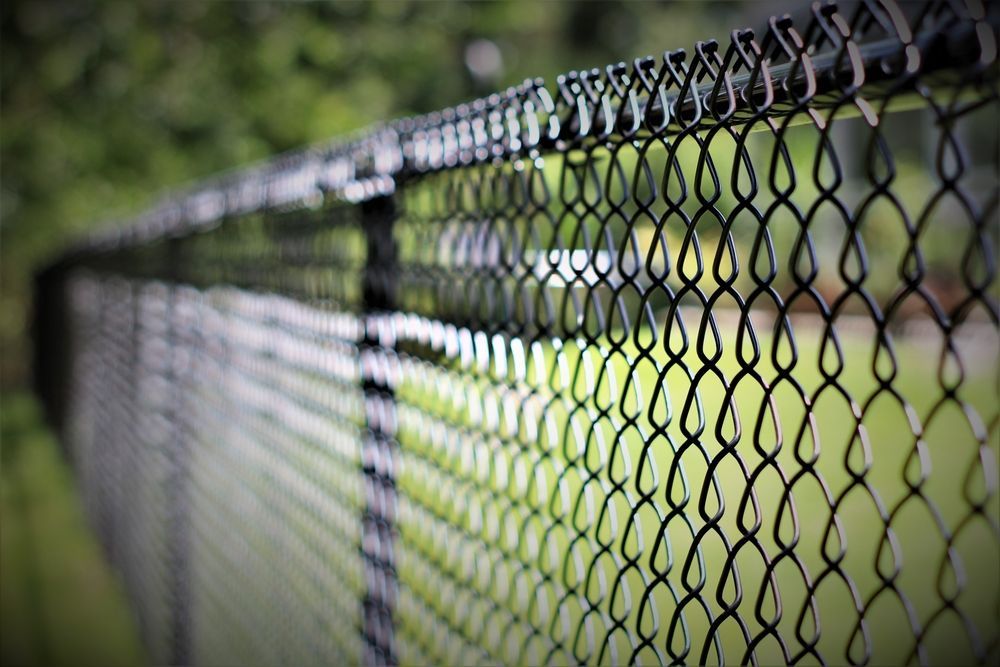 A Black Chain Link Fence — Smiddy's Services In Terrigal, NSW