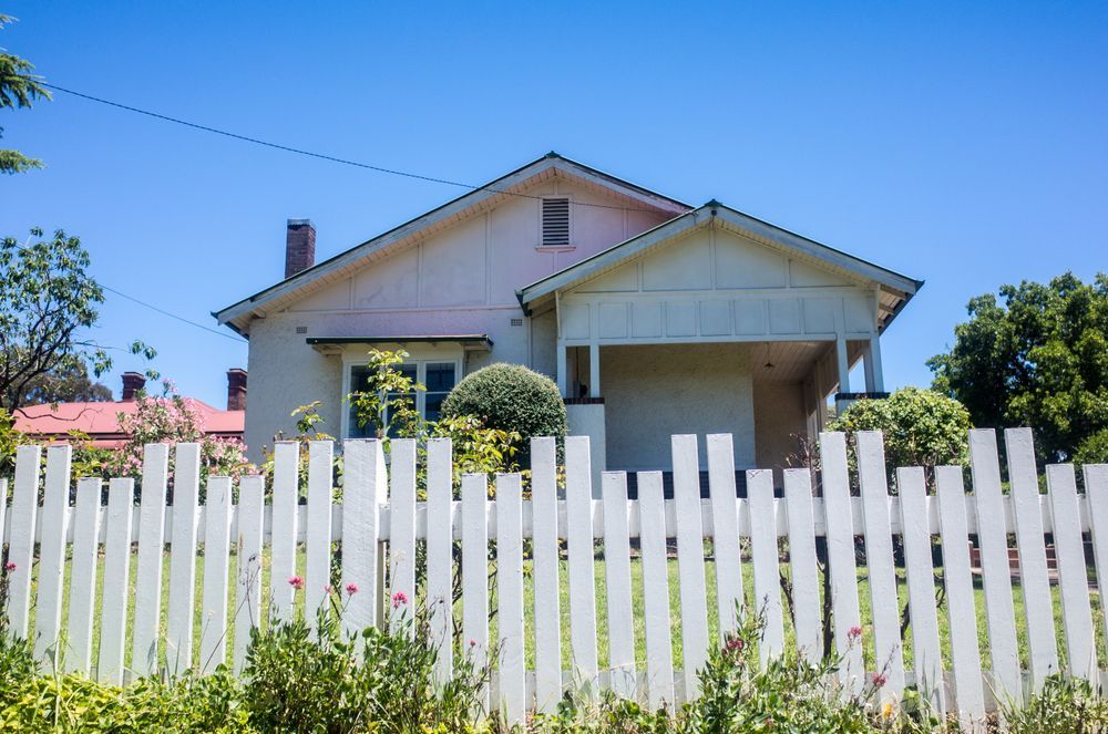 A Wooden Fence Is In Front Of A House — Smiddy's Services In The Entrance, NSW