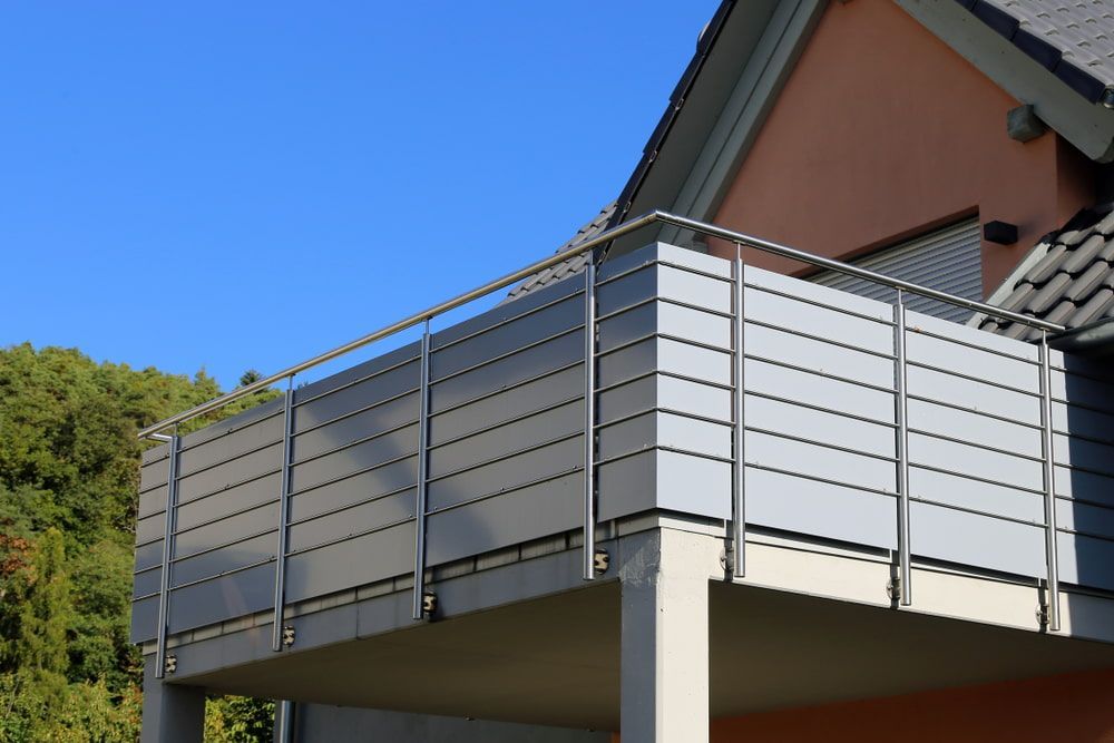 A Balcony With A Metal Railing On The Side Of A House — Smiddy's Services In Gosford, NSW