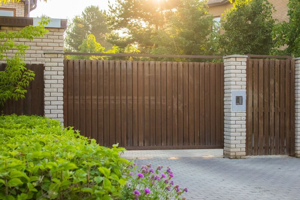 There Is A Wooden Gate In Front Of A House — Smiddy's Services In Central Coast, NSW
