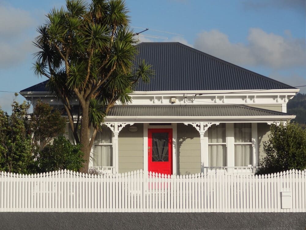 A House With A Red Door And A White Picket Fence — Smiddy's Services In Tacoma, NSW