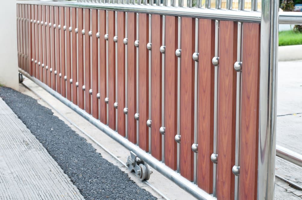 A Sliding Gate Made Of Wood And Stainless Steel — Smiddy's Services In Tacoma, NSW
