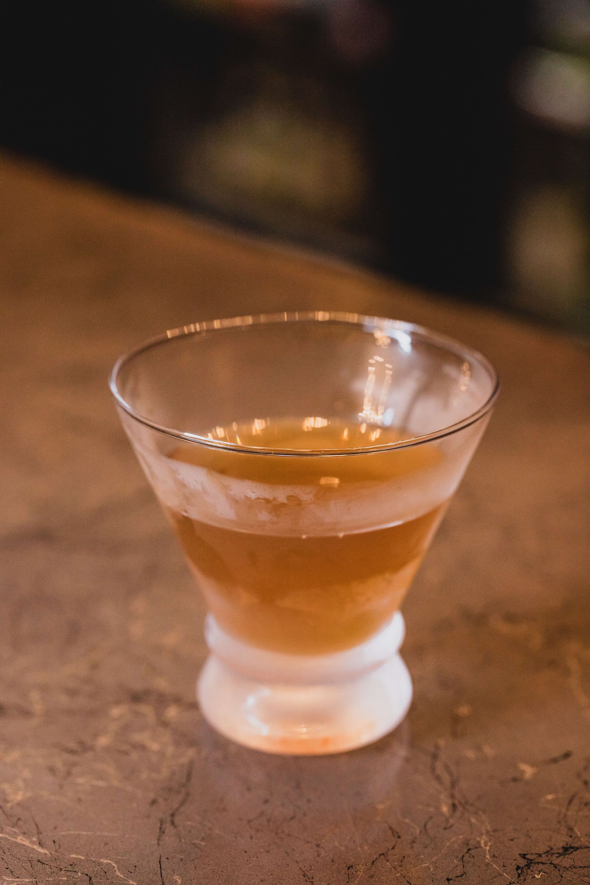 a close-up of a glass of Churchill bourbon cocktail on a table.