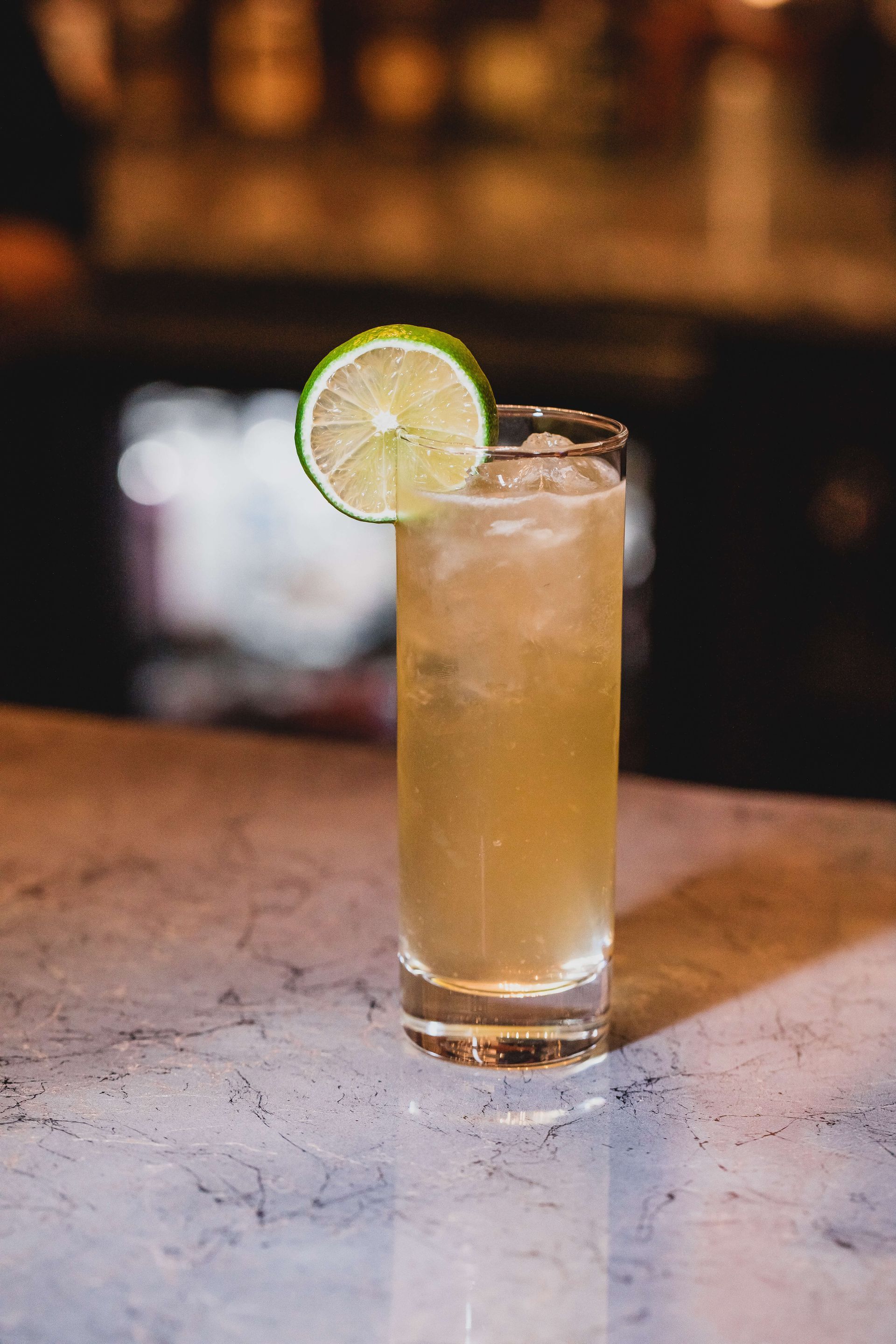 a glass with an Irish buck cocktail with a slice of lime in it