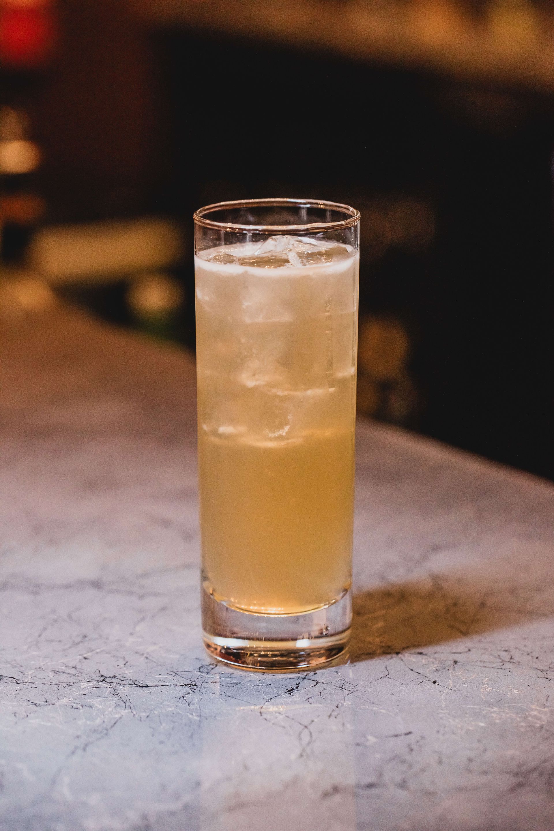 a glass of a Branch Water with an orange peel on the rim