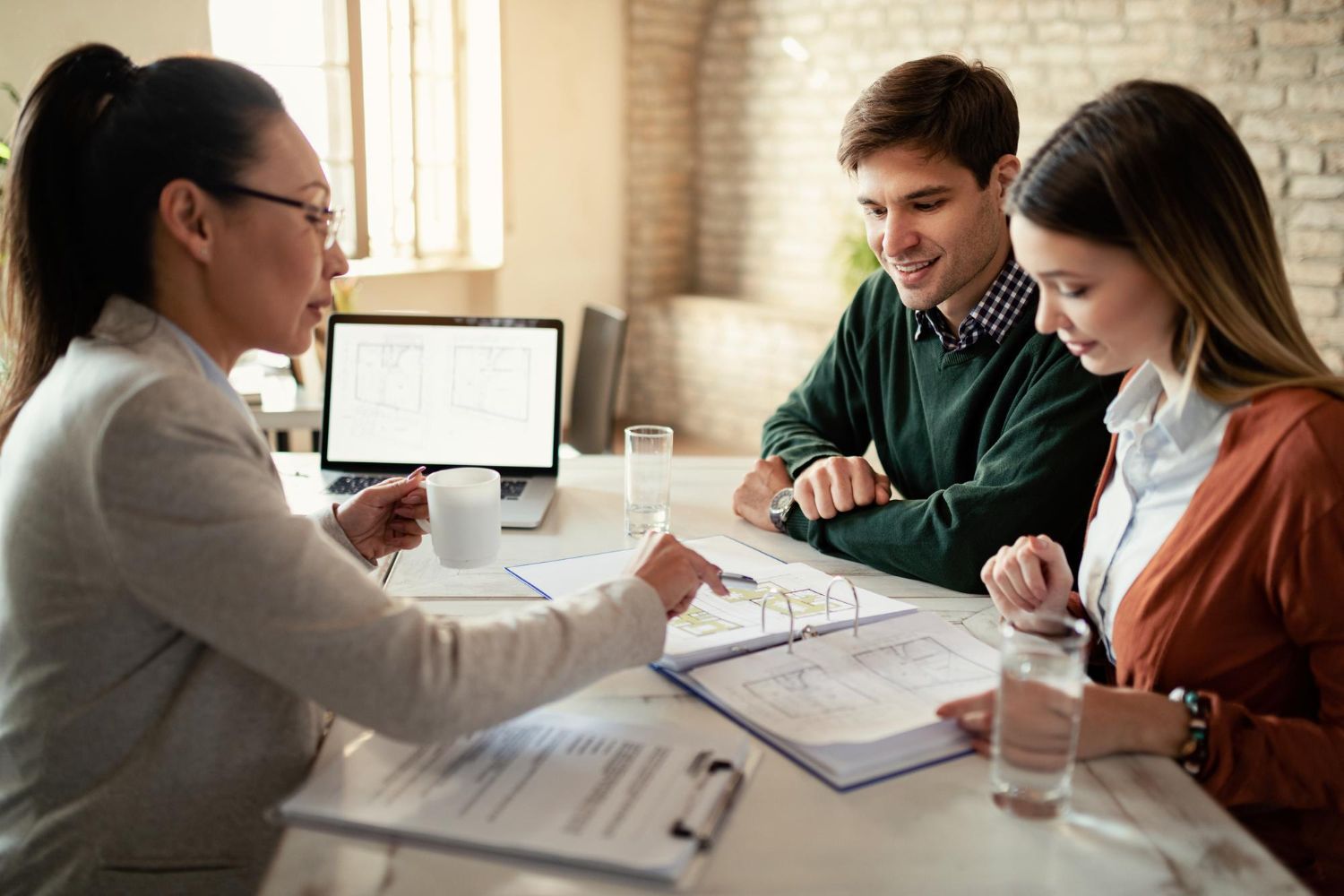 A woman is sitting at a table with a man and a woman.