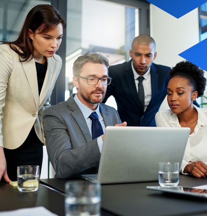 A group of people are looking at a laptop computer.