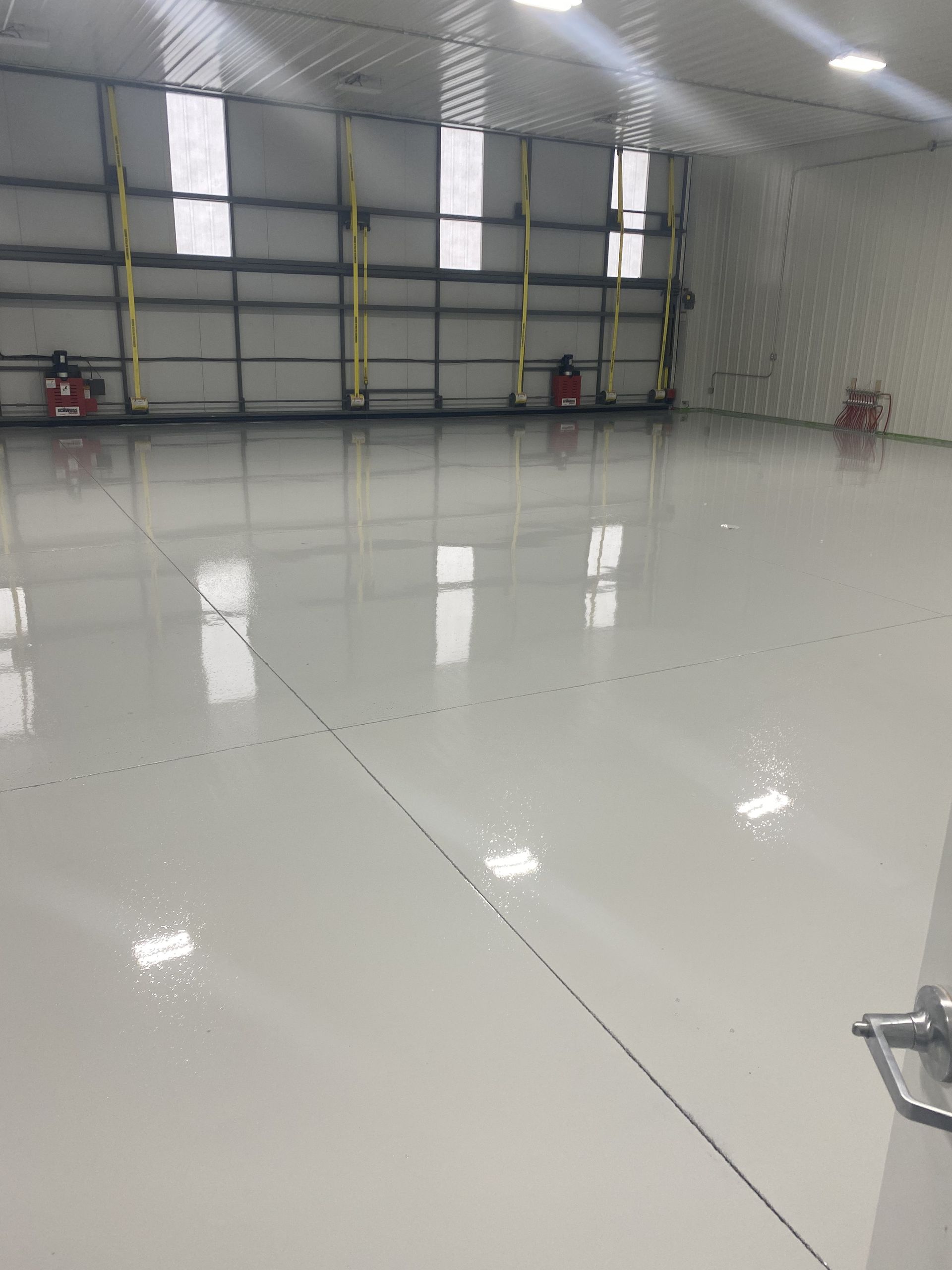 Construction site: crane over a building under construction, blue sky with clouds.