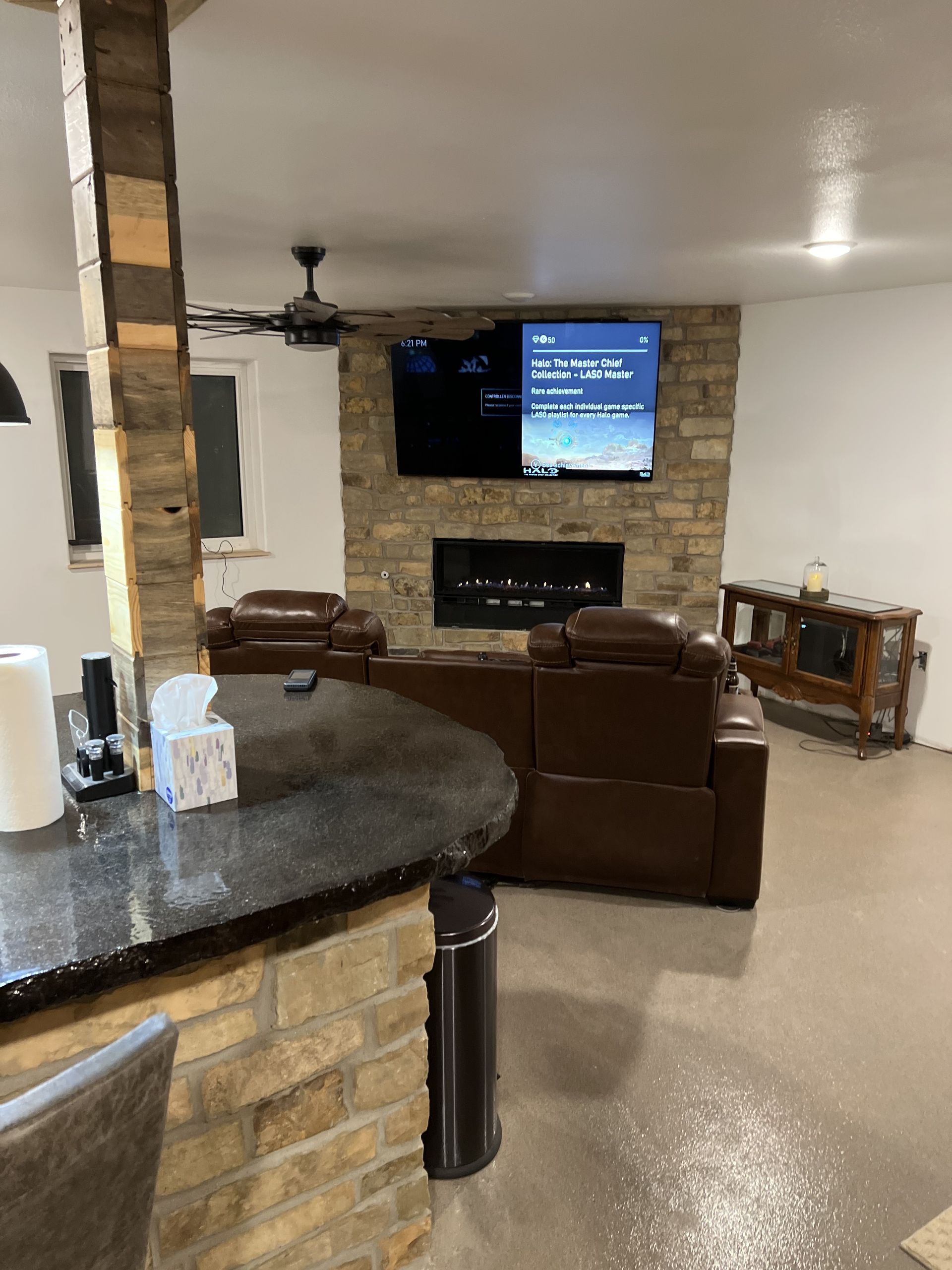 Construction site: workers in yellow vests, surrounded by materials and concrete framework.