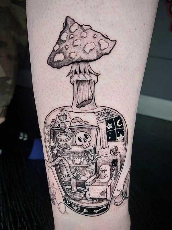A tattoo of a mushroom growing out of a bottle on a person 's leg.