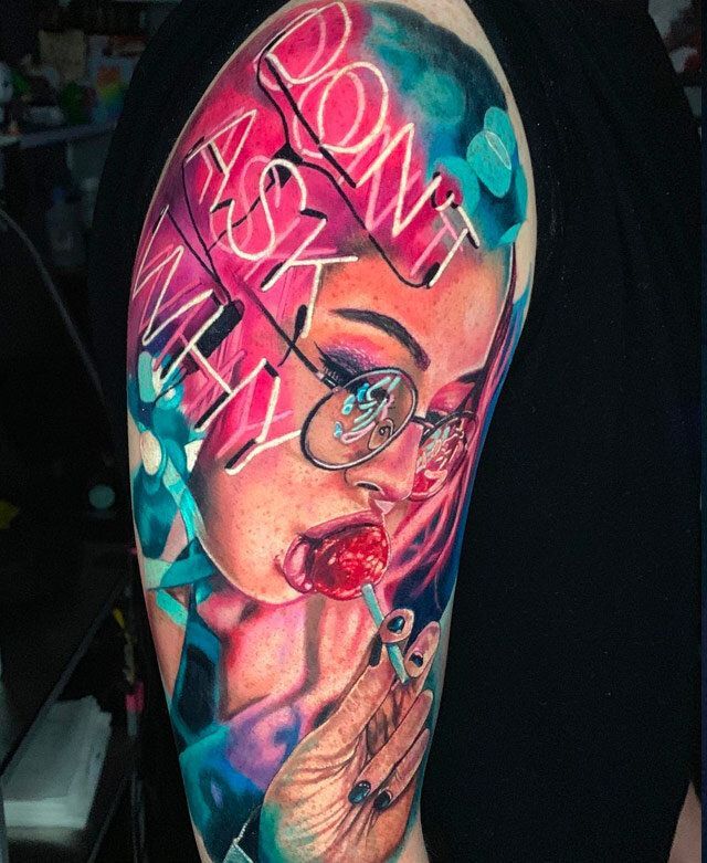 A man has a tattoo of a woman with glasses on his arm.