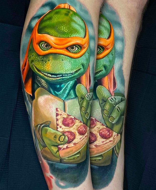 A tattoo of a teenage mutant ninja turtle holding a slice of pizza.