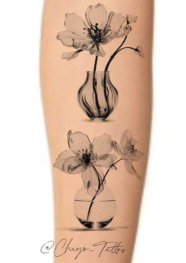 A tattoo of flowers in vases on a person 's arm
