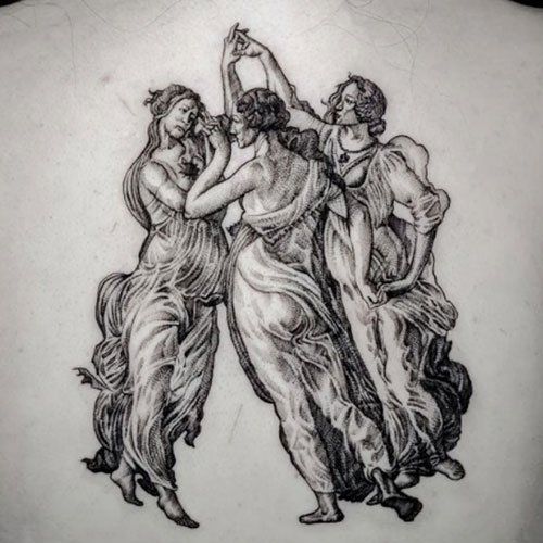 A black and white tattoo of three women dancing on a person 's back.