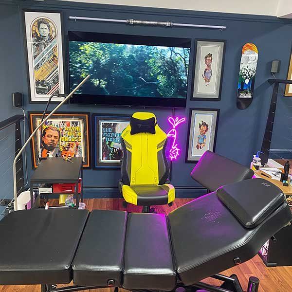 A yellow chair is sitting in front of a television in a room.