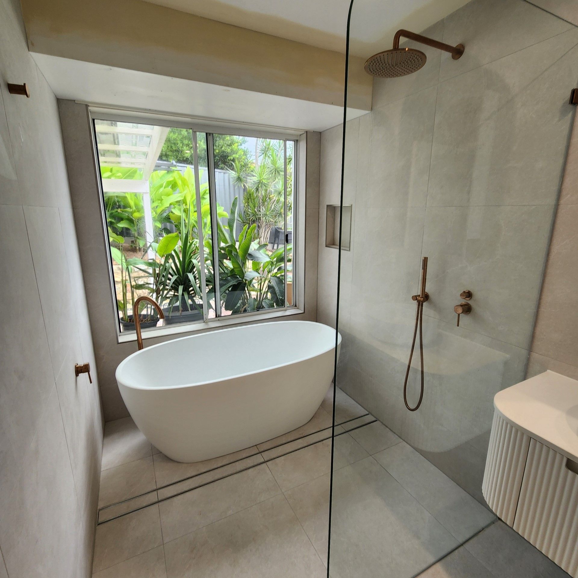 A bathroom with a bathtub and a walk in shower