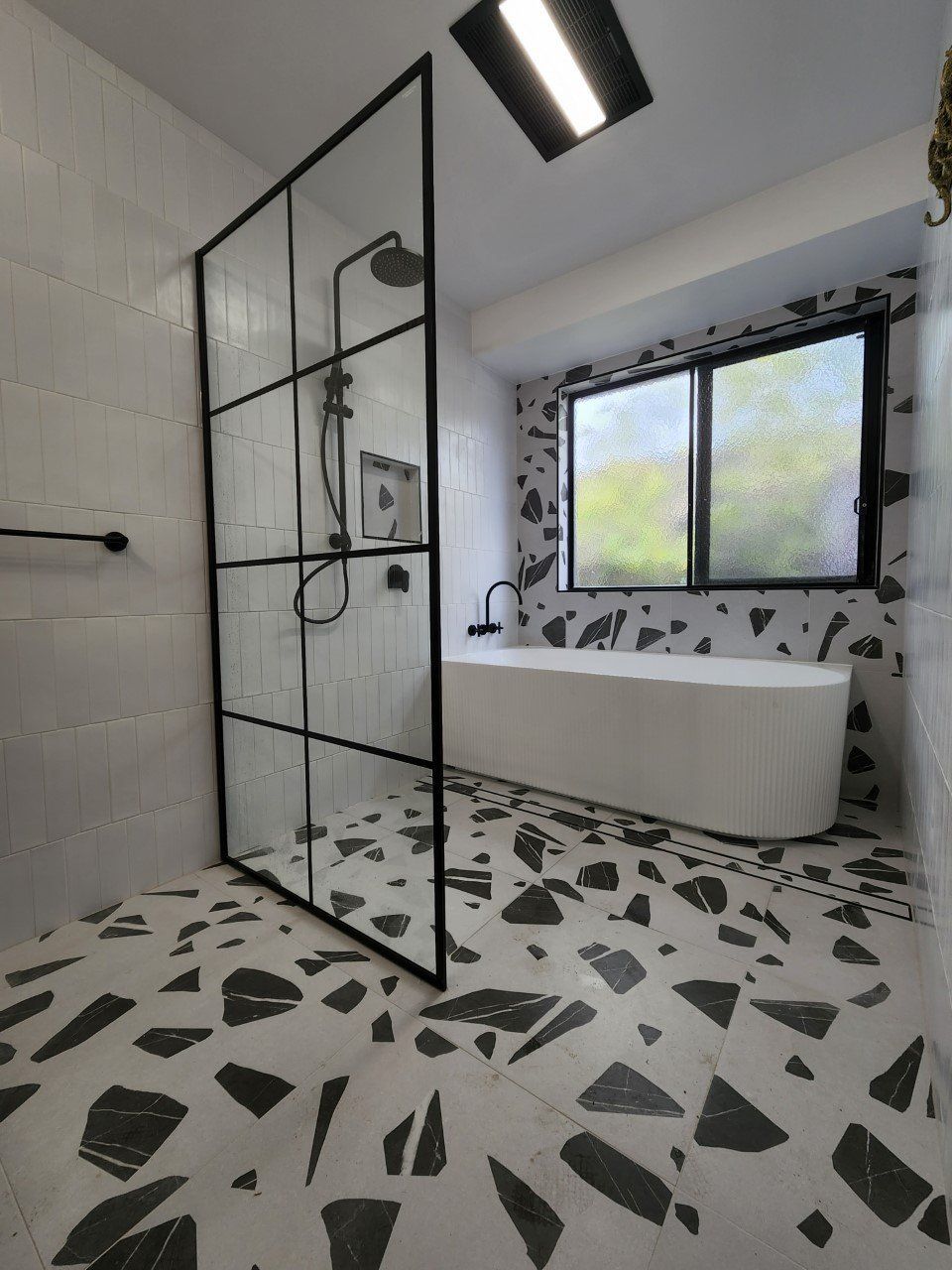 A bathroom with a bathtub and a walk in shower