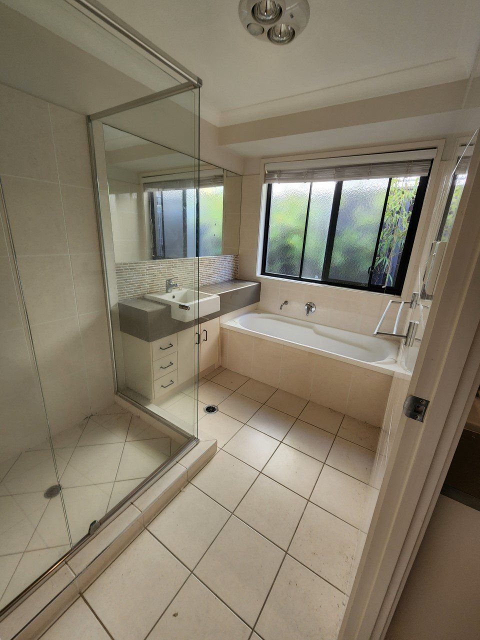 A bathroom with a bathtub and a shower
