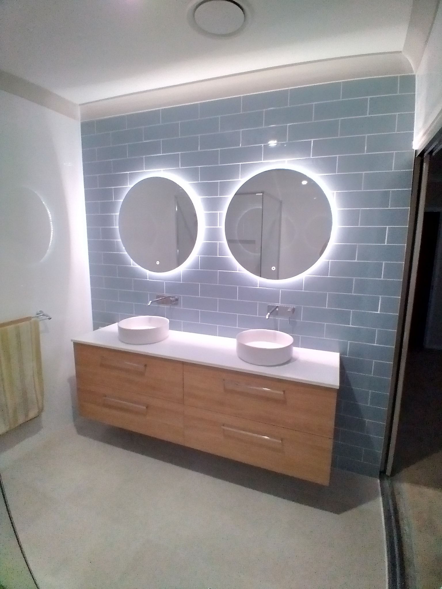 A bathroom with two sinks and two mirrors.
