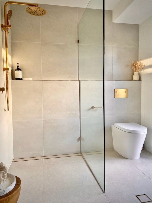 A bathroom with a walk in shower and a toilet.