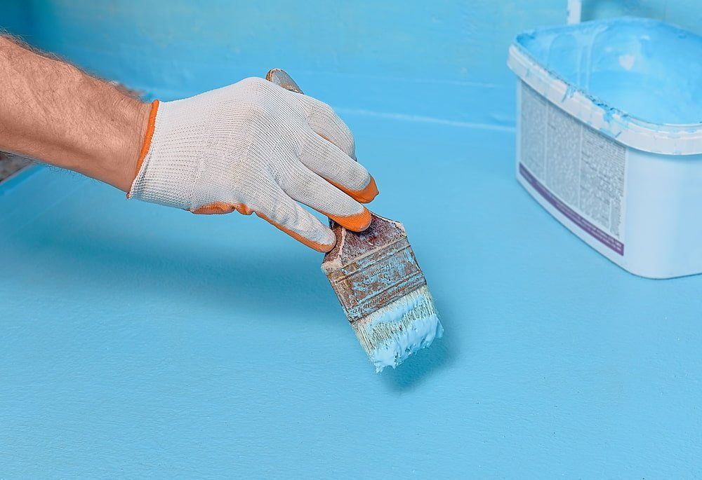 Applying Water Proofer Paint — Bathroom & Laundry Renovations in Coomera, QLD