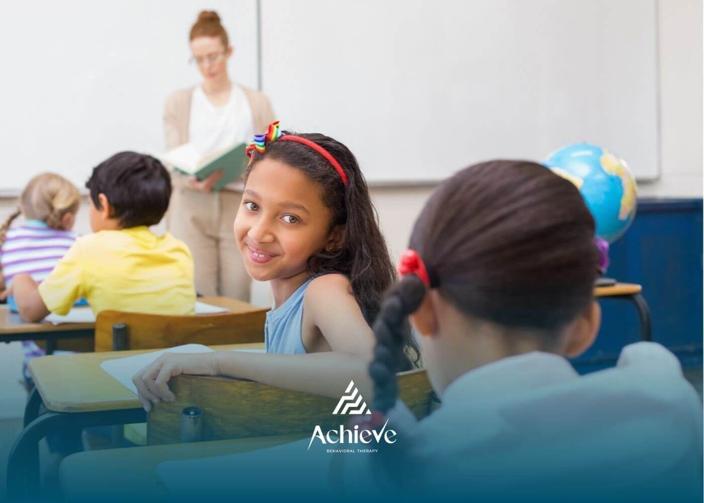 Elementary classroom with children with autism engaged in learning activities.