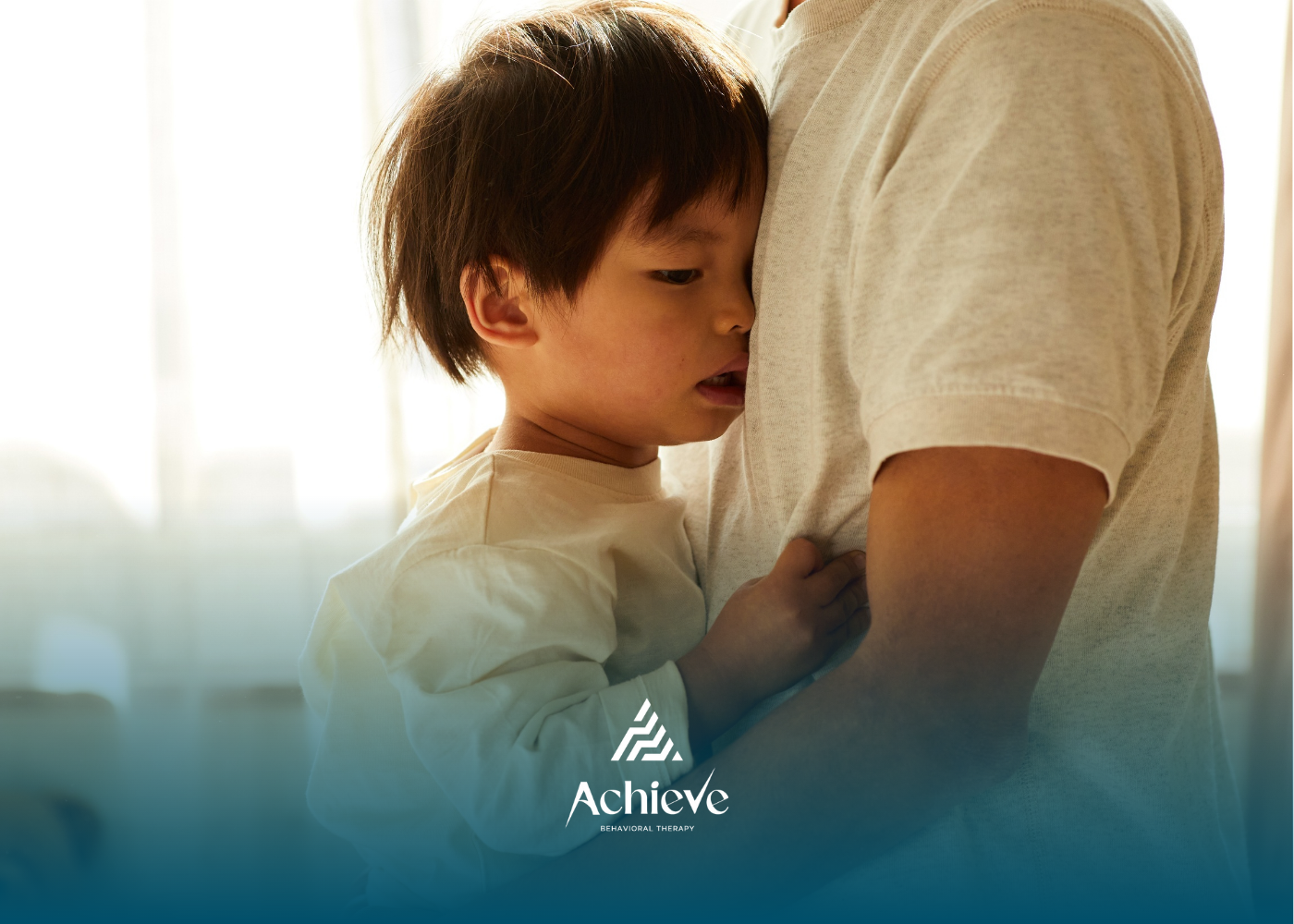 Child hugs an adult close. The child has their face on the adult's chest. Window in the background.