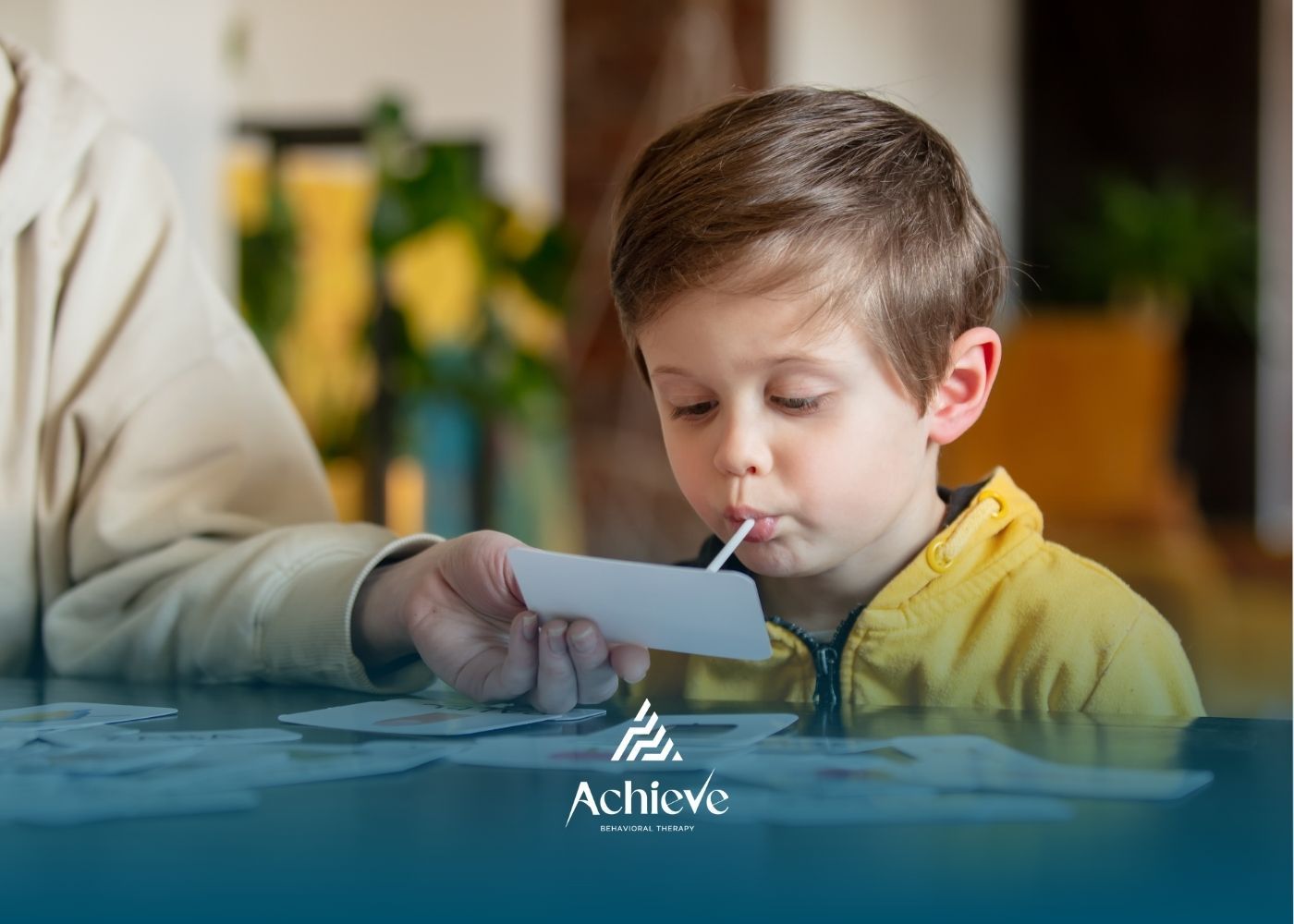 Therapist assists a child walking on a course in a therapy room.
